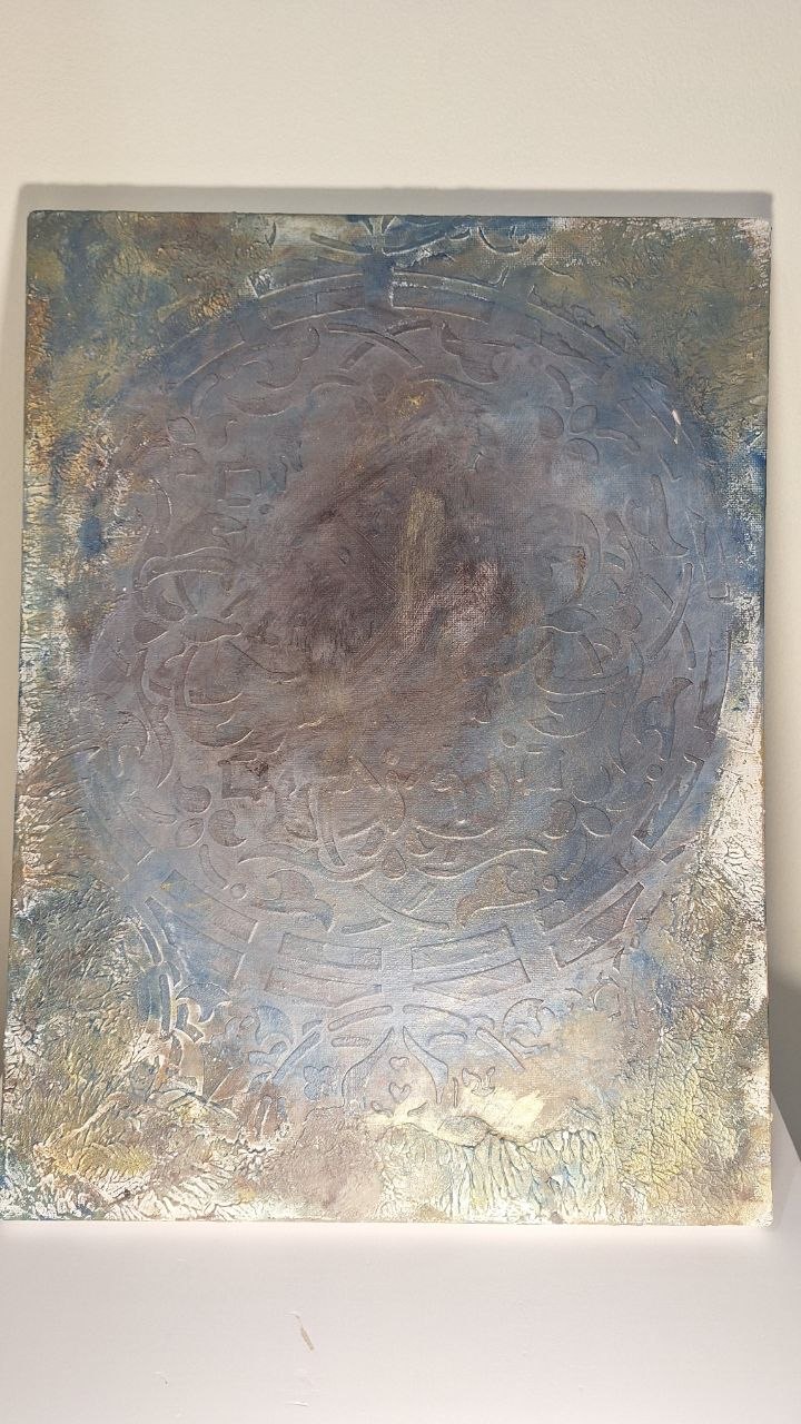 Soft blue and metallic artwork with a circular medallion
