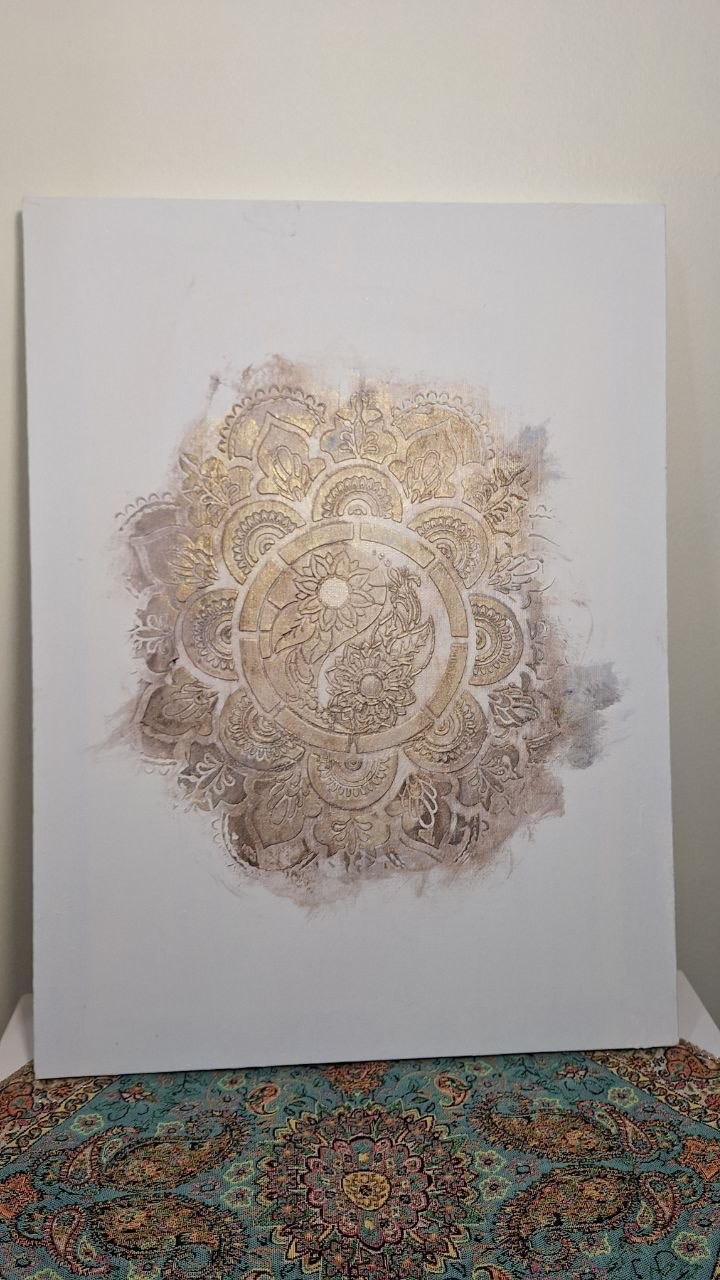 Light artwork with a delicate gold ornamental medallion